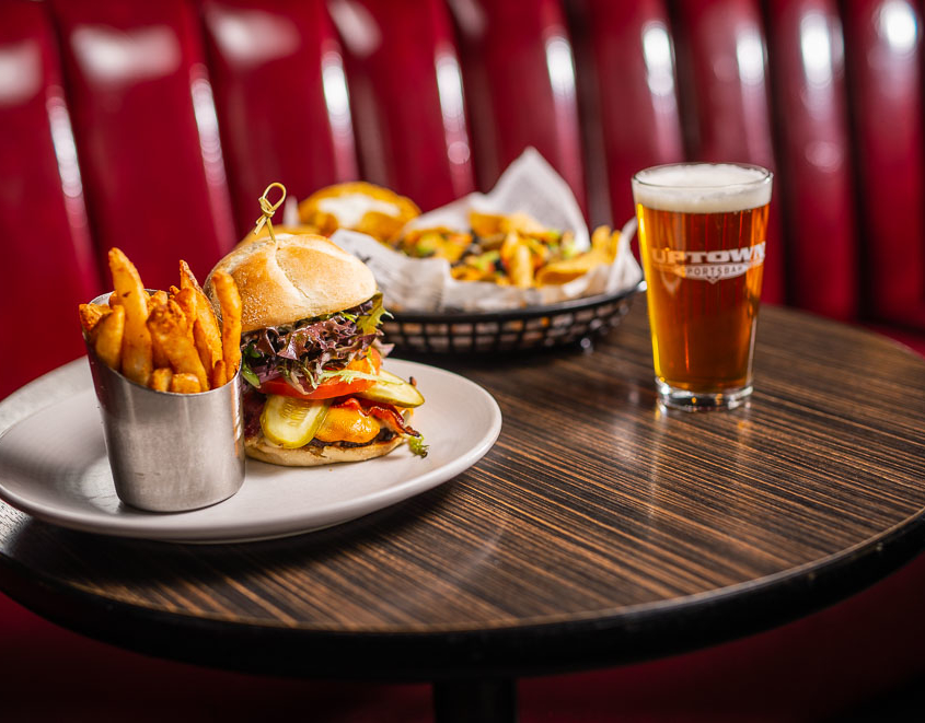 Burger, fries, beer on a table